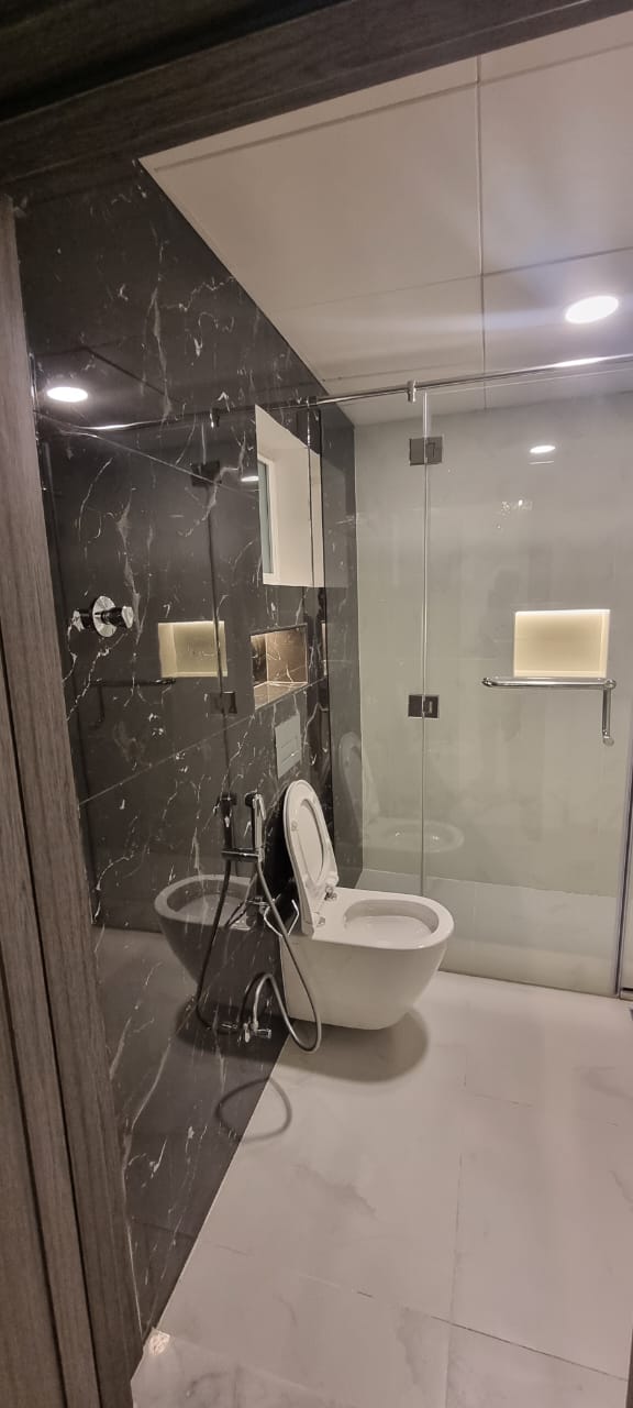 Dark marble bathroom with walk-in shower.