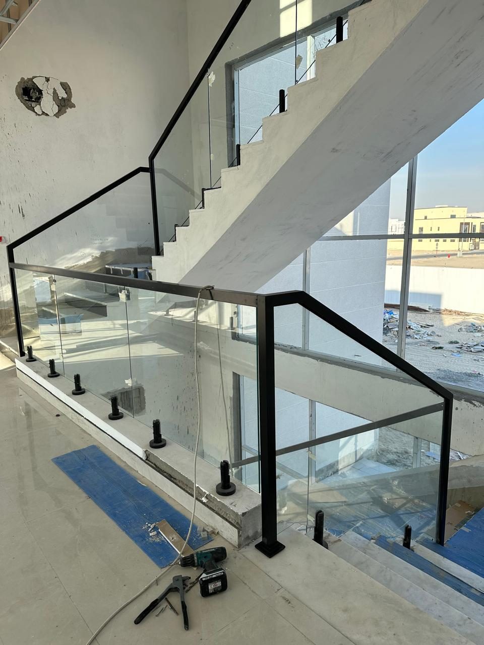 Marble staircase with frameless glass balustrade