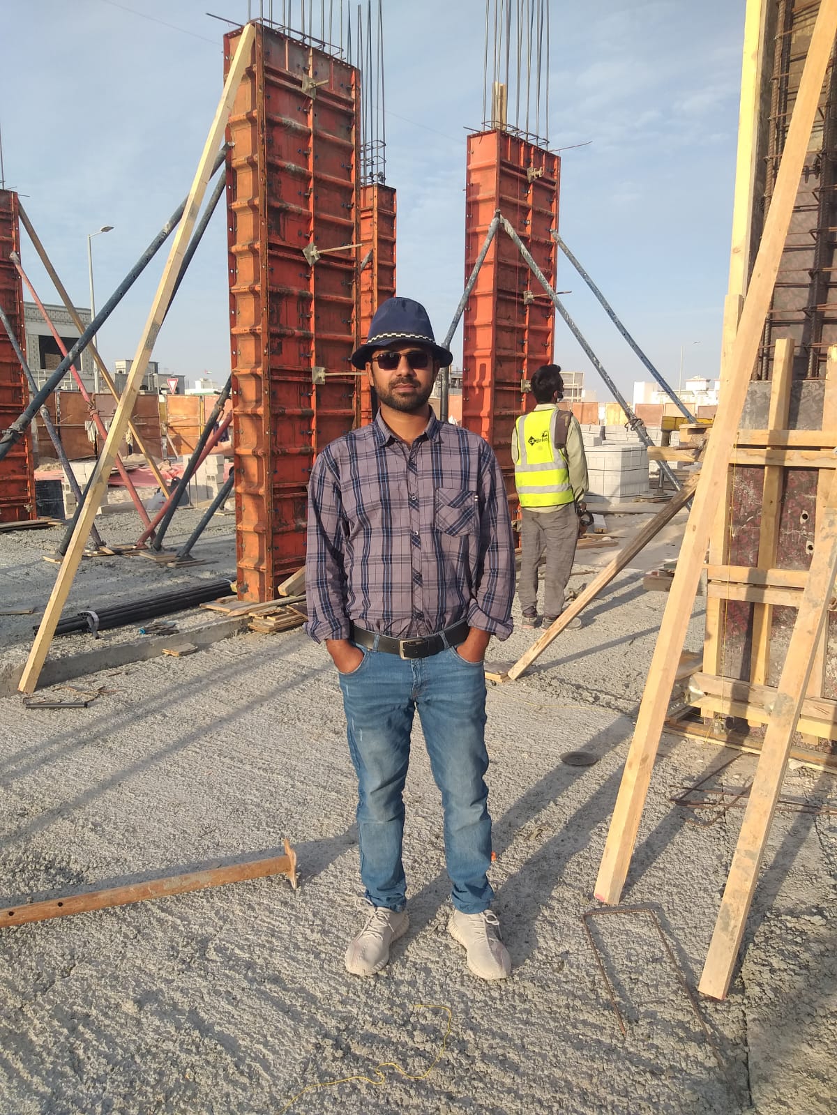 Engr. Tayyab standing among column formwork at golden hour, Shamkha South.